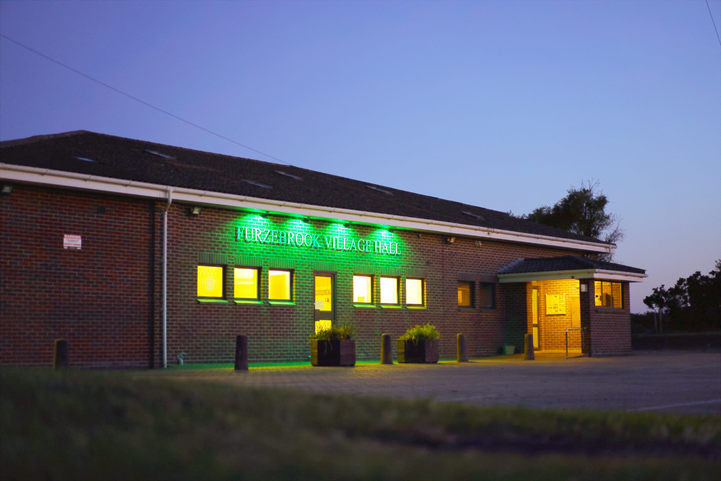 Furzebrook Village Hall lit up at dusk